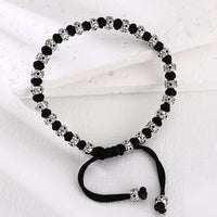 [full] - Sterling silver bracelet with star-engraved beads and black cord detailing.