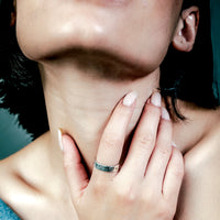 [full] Close-up of a woman with a sterling silver ring on her finger.
