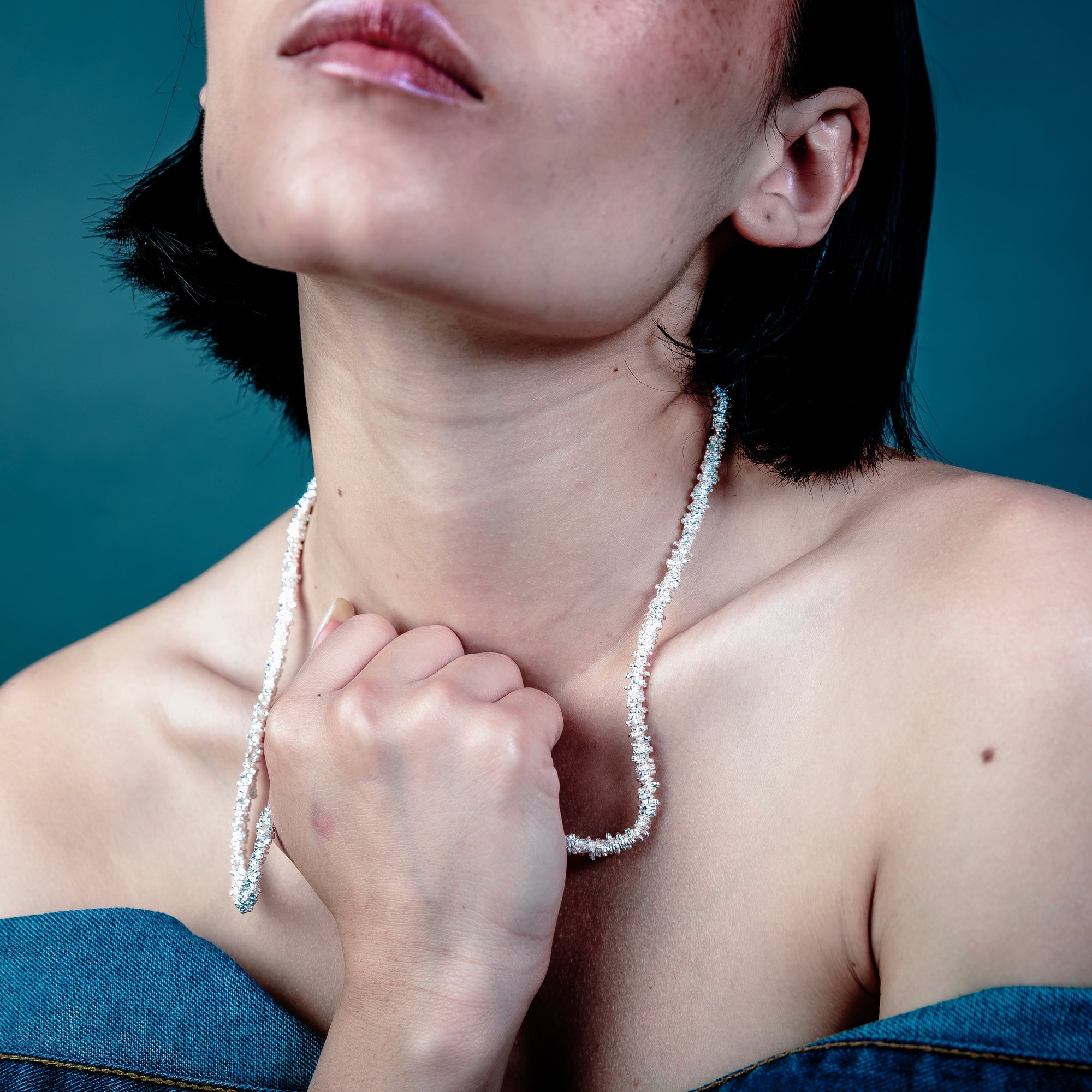 [full] - Person wearing AURA sterling silver necklace
