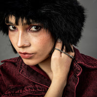 [full] Close-up of a person wearing a silver and ruthenium bracelet with a dark background