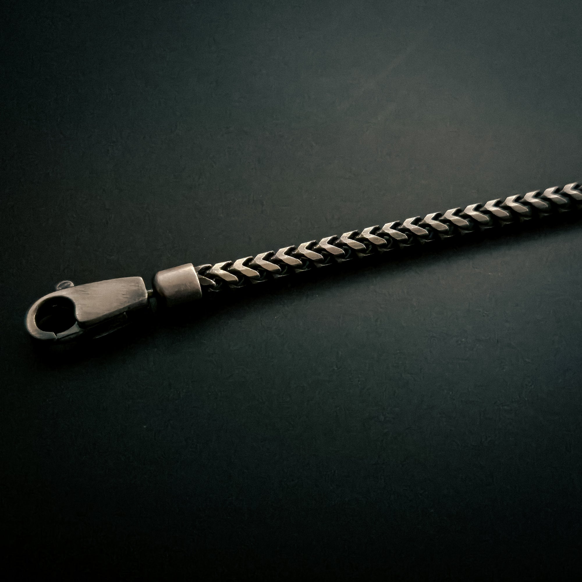 [full] - Sterling silver Franco chain bracelet with octagonal centerpiece and dark ruthenium plating.