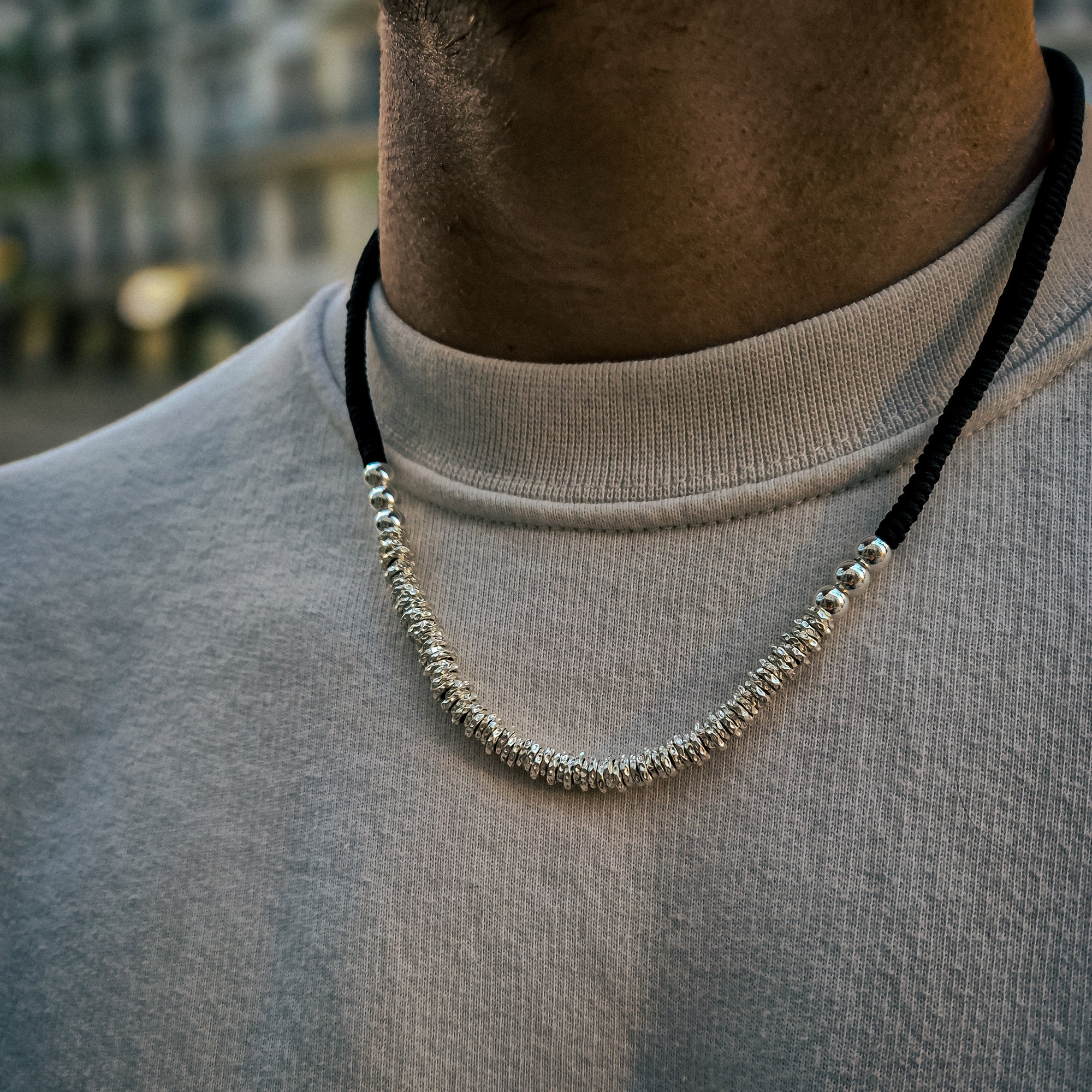 [full] - Sterling silver bead necklace combined with black handcrafted cord, featuring polished and woven textures.