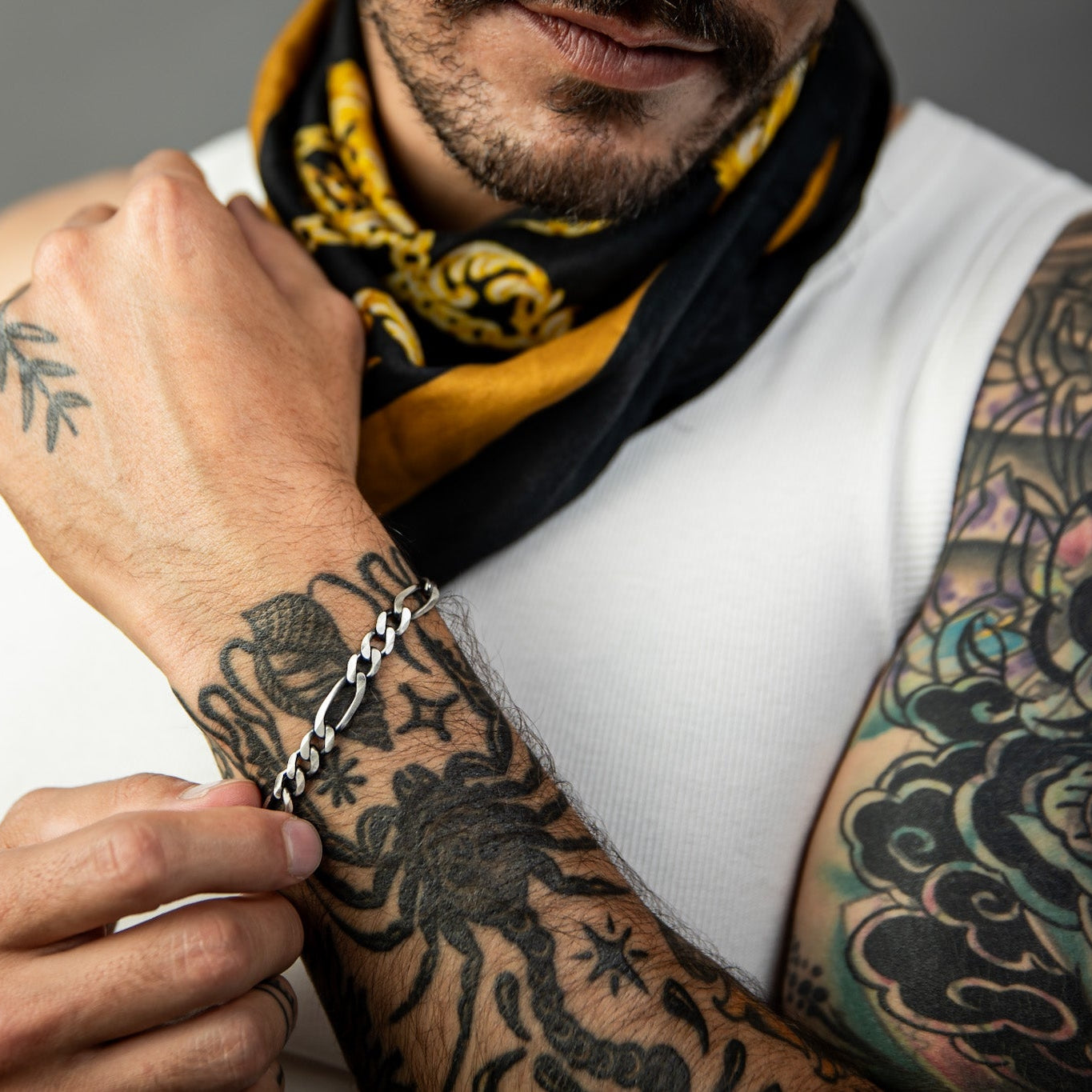 [full] - Person with tattoos on arms wearing a gun-metal sterling silver bracelet with a brushed finish.