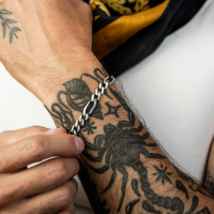 [full] - Close-up of a gun-metal sterling silver bracelet with a brushed finish.
