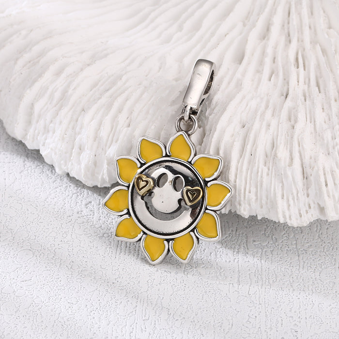 [full] Pendant in sterling silver with sunflower and happy face.