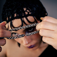 [full] - Close-up of twisted link sterling silver bracelet with ruthenium plating, brushed gun-metal finish, and sculpted hook clasp.